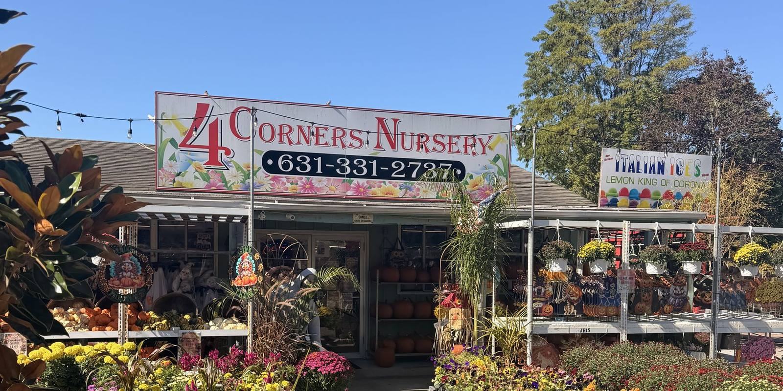 The 4 Corners Nursery sign over the entrance and flower benches