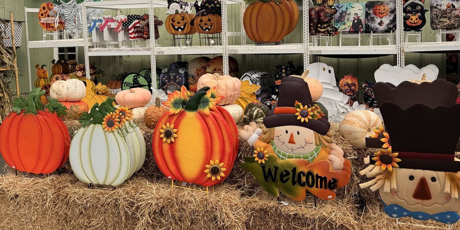 Fall display of pumpkins and scarecrows on hay bales