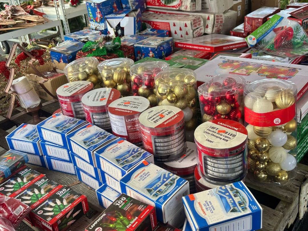 Tables of boxed ornaments and holiday decor