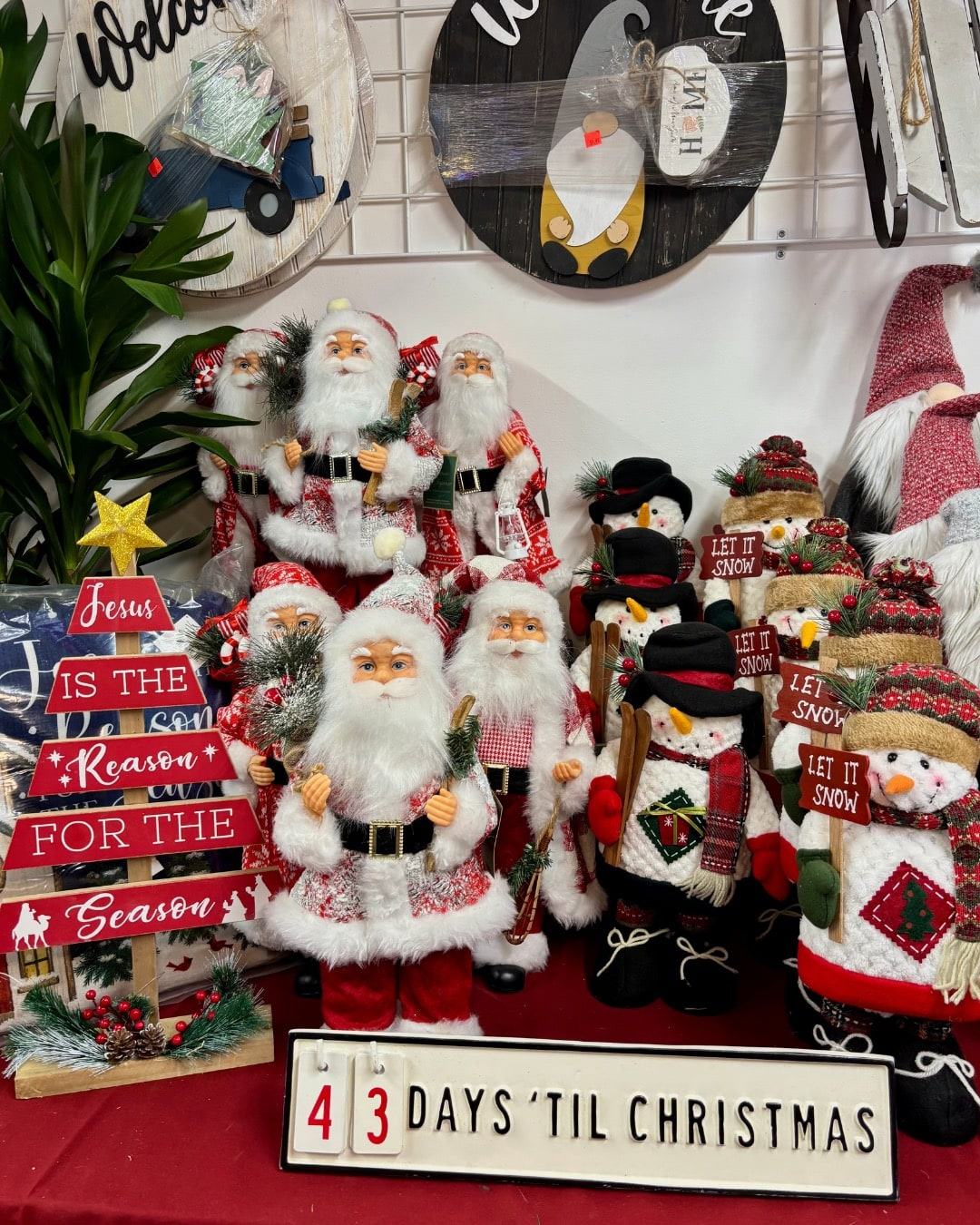 Santa figures and snowmen on a holiday display table